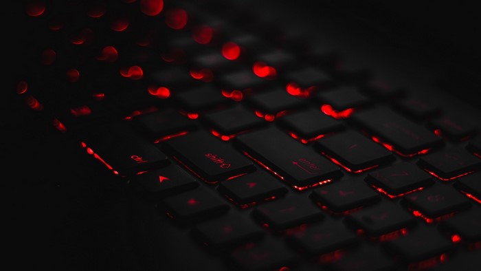 Close-up of a black keyboard with red backlighting