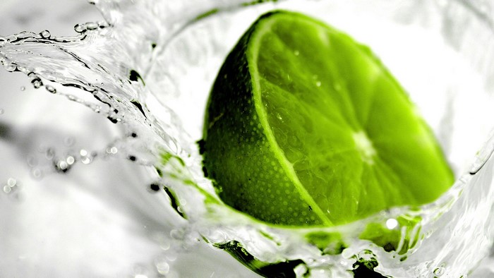 Lime slice splashing in water