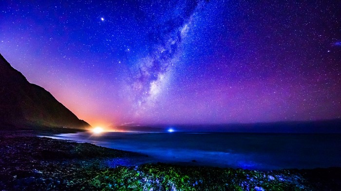 Milky Way over a rocky beach at night