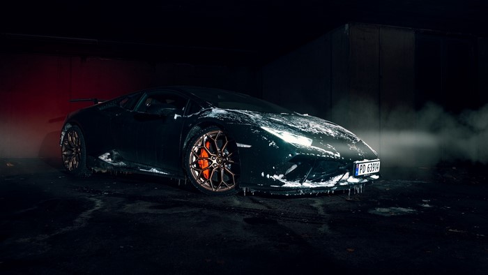 Black Lamborghini covered in snow and ice
