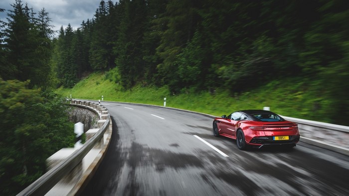 Red Aston Martin DBS Supercar on a Wet Road