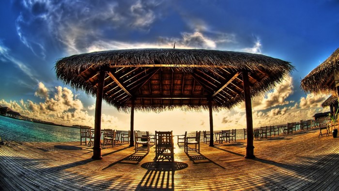 Tropical resort with thatched roofs and ocean view