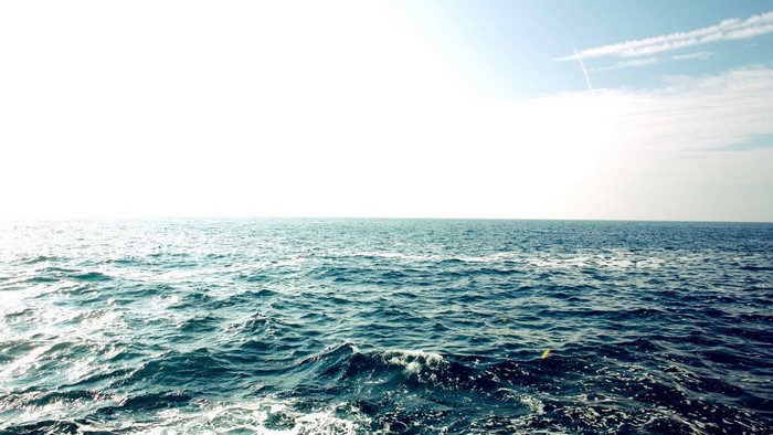 Ocean waves under a bright sky