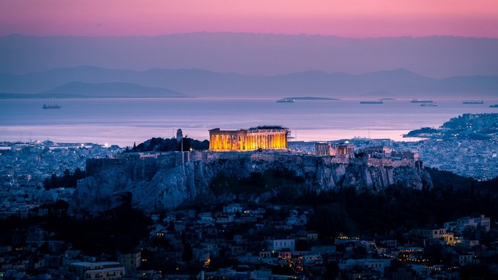 The Acropolis of Athens at twilight with the sea in the background