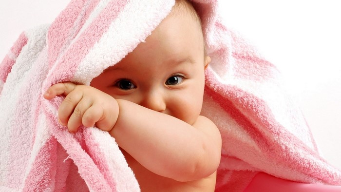 Baby wrapped in a pink and white striped towel