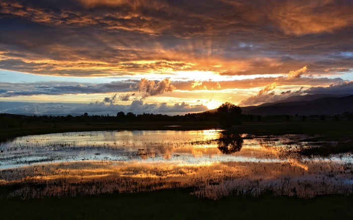 Sunset over a flooded field with reflections