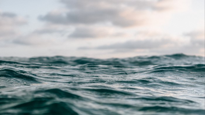 Ocean waves under cloudy sky