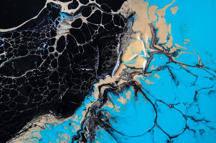 Abstract paint with black, teal, and gold colors