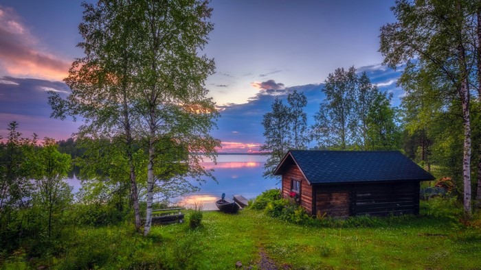 Cabin by a lake at sunset in Finland