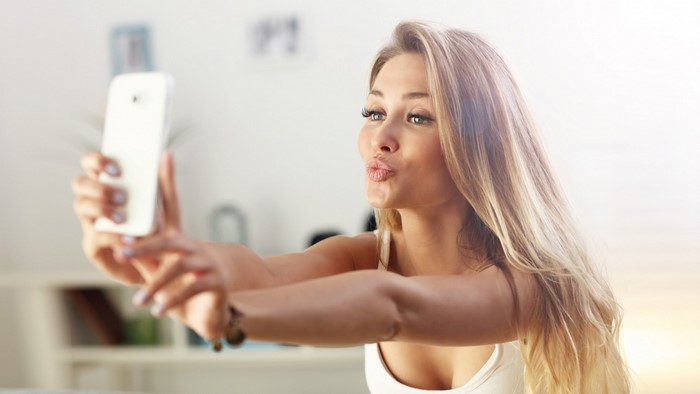 Woman taking a selfie with a smartphone