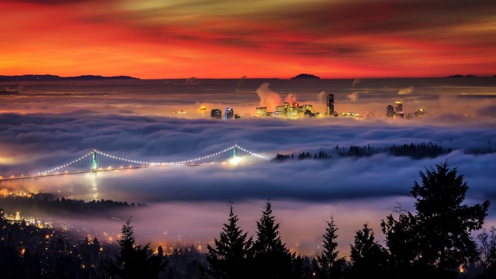 Vancouver skyline and Lions Gate Bridge in fog at sunset