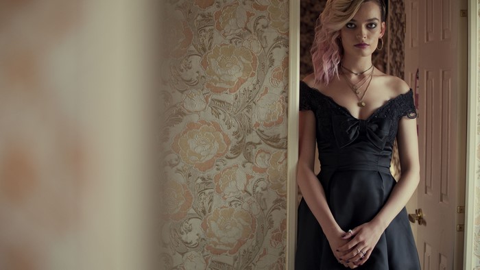 Emma Mackey in a black dress