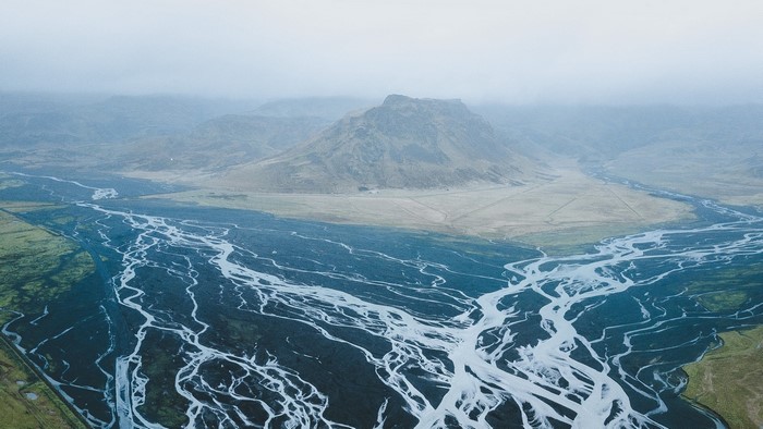 Aerial view of braided river and mountain in Iceland