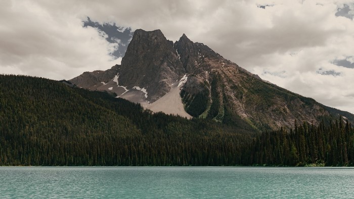 Mountain peak over a forest and lake