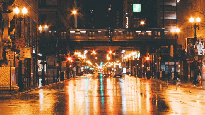 Night street with train and reflections