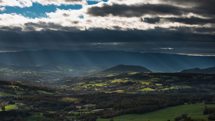 Sunbeams over a valley and mountains