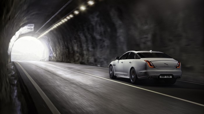 White Jaguar XJ driving through a tunnel