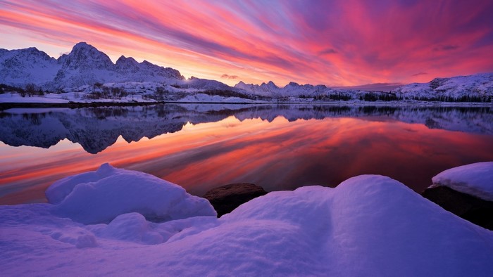Snowy Mountains Reflecting Sunset Over Lake