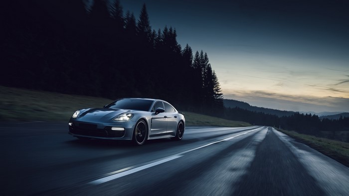 Porsche Panamera Turbo on a wet road at dusk