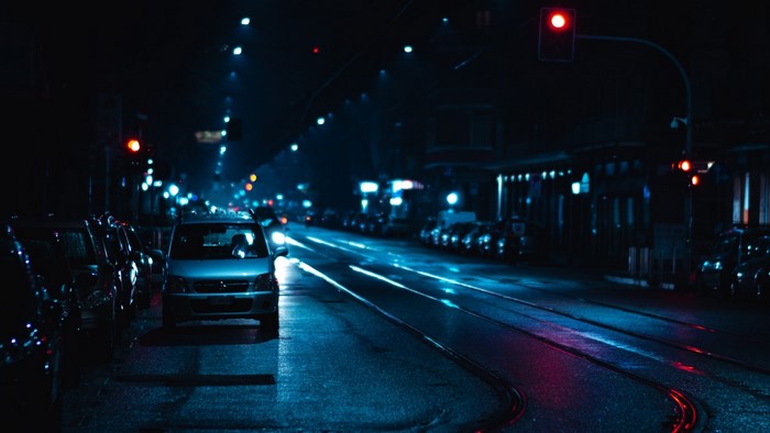 Street at night with traffic lights and cars