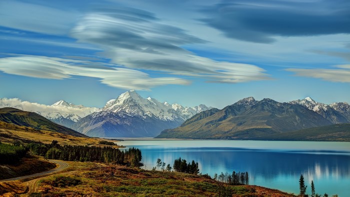Snow-capped mountains reflected in a lake in New Zealand