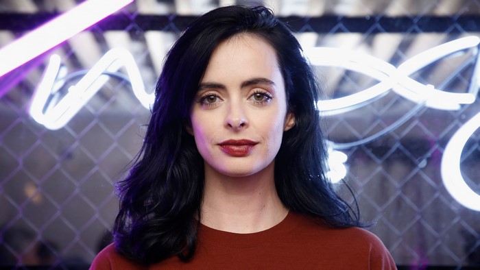Krysten Ritter in front of neon lights