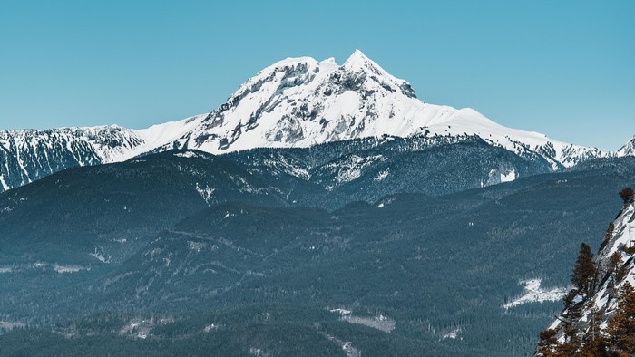 Snow-capped mountains under a clear blue sky