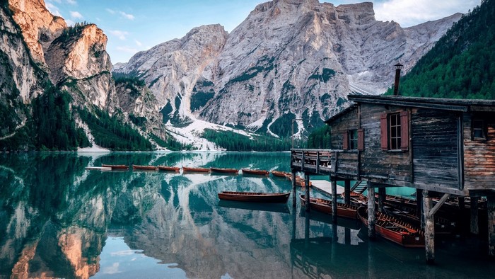 Wooden boathouse on a lake with mountains