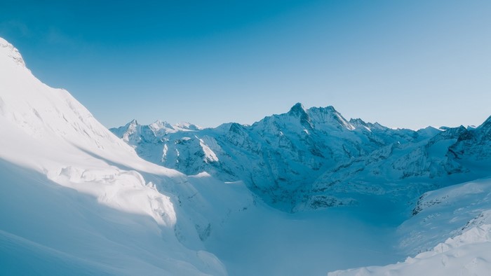 Snowy mountain range under a clear blue sky