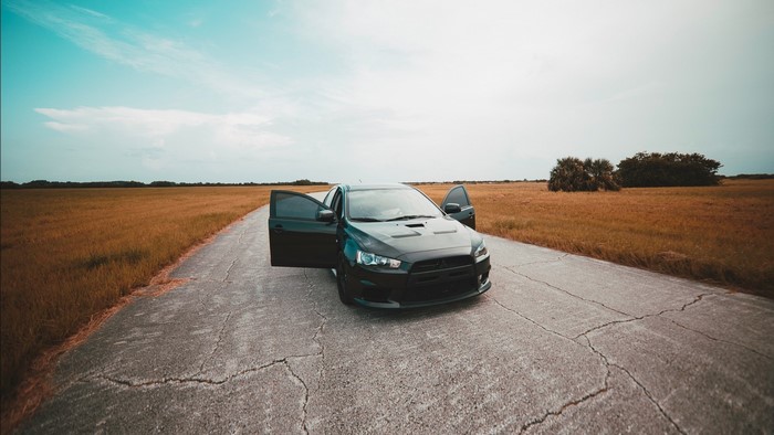 Black Mitsubishi Lancer on a rural road