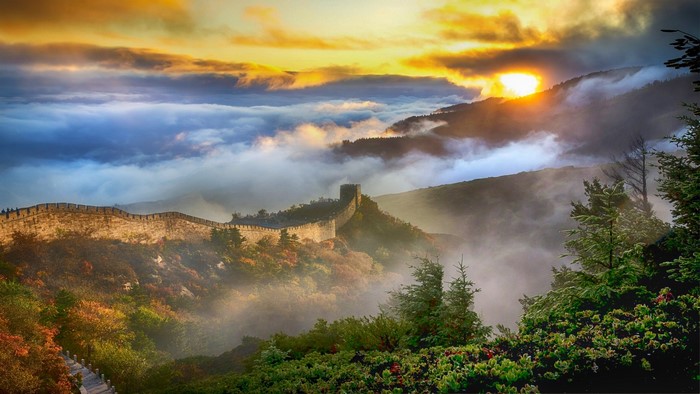 Great Wall of China at sunrise with fog
