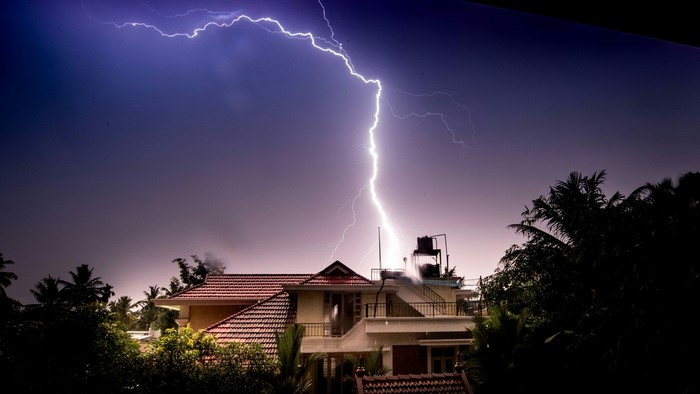 Lightning strikes a house during a storm