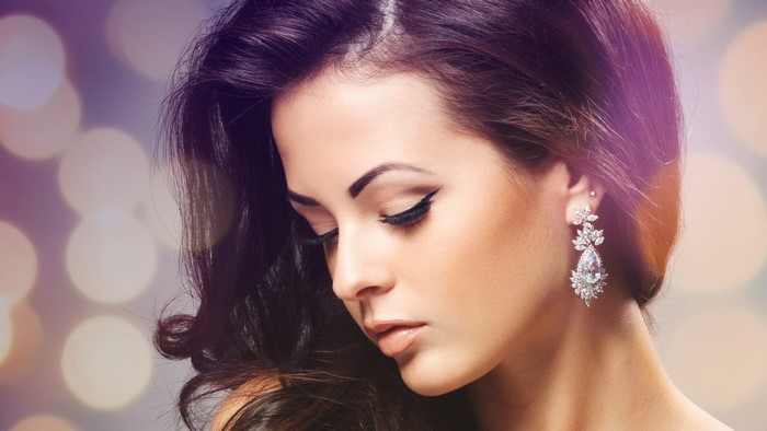 Woman with diamond earrings and makeup