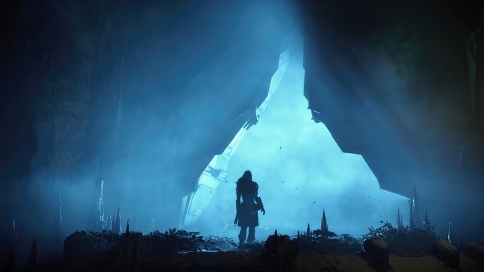 Aloy in a cave entrance in Horizon Zero Dawn