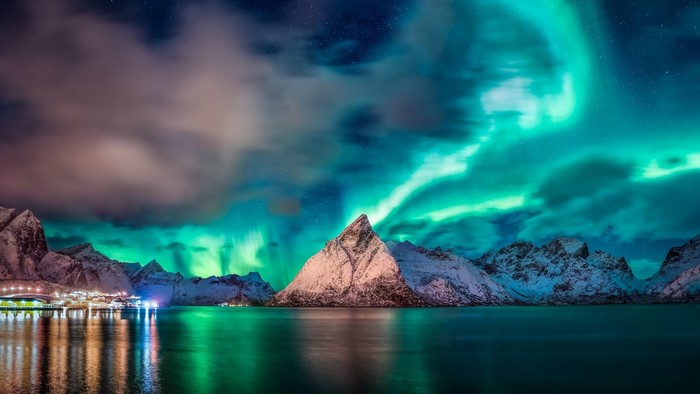 Aurora Borealis over Mountains and Village