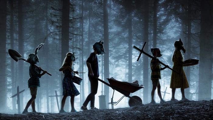 Children in masks with tools in a forest