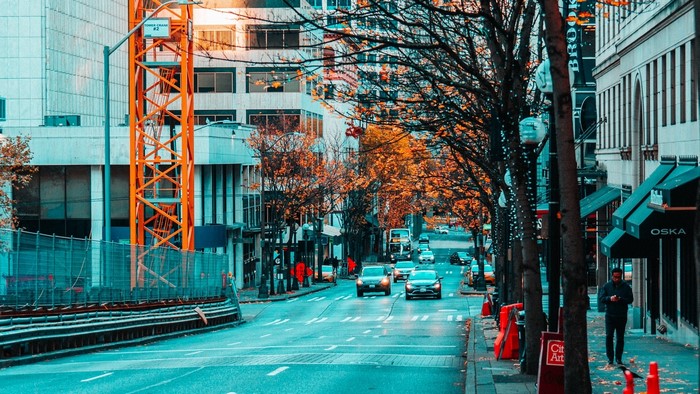 Street scene with crane and autumn trees