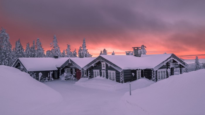 Snowy cabins at sunset