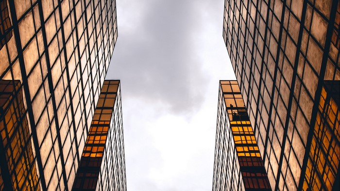 Golden skyscrapers against a cloudy sky