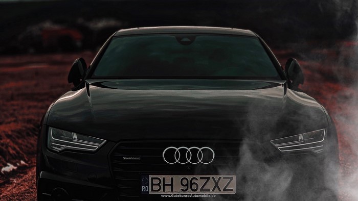 Black Audi A7 with smoke