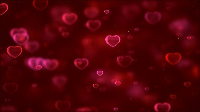 Red and pink hearts floating on a dark red background