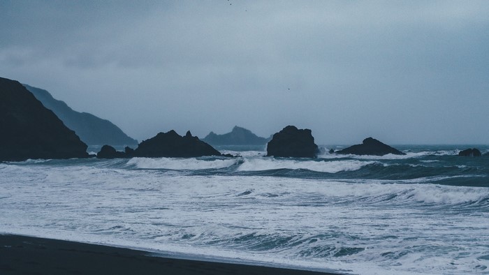 Ocean waves crashing on rocks and shore