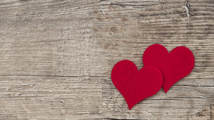 Two red hearts on a wooden background