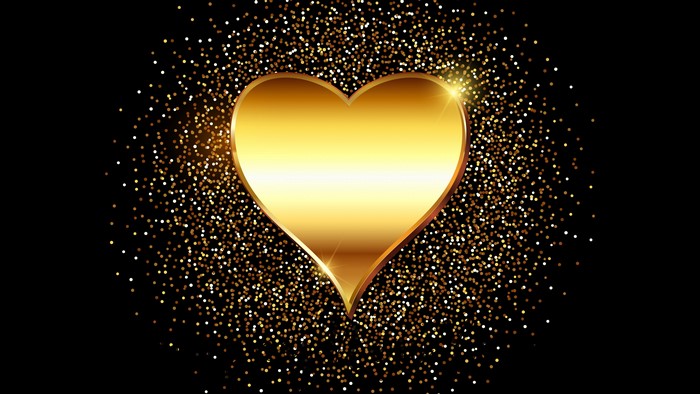 Golden heart with glitter on black background