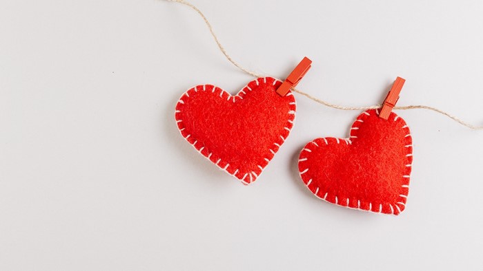 Two red hearts on a string