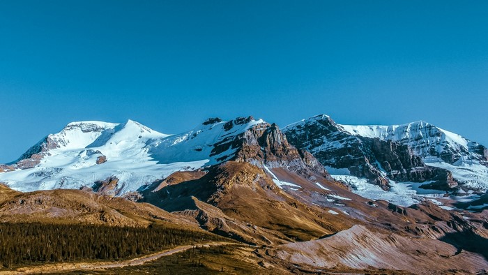 Snow-capped mountains under a clear blue sky