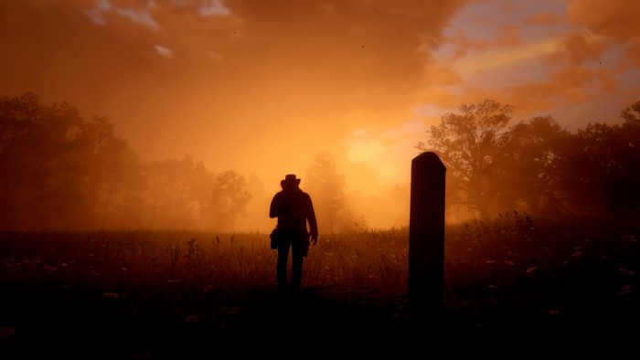 Man in cowboy hat in Red Dead Redemption 2 at sunset