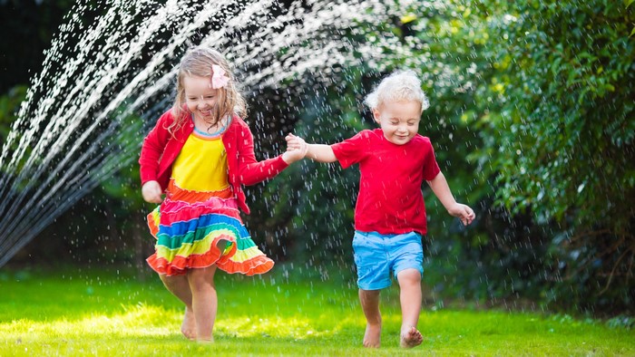 Children playing in sprinkler