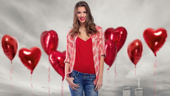 Woman with red heart balloons
