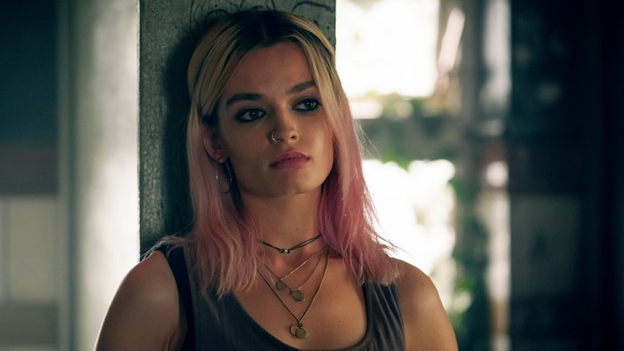 Emma Mackey with pink hair and necklaces